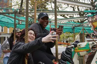 SU junior Alicia Harris and June Huynh take selfies on the carousel. 