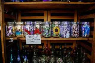 Hand-painted jars sit on the shelf in Martee Crowley's glasswork booth. 