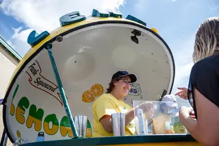 Rachel Maloney attends to a customer in the one of many lemonade stands scattered all over the fair grounds.