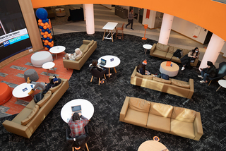 Students work and relax in the first floor lounge, which can be seen from the overlooking balcony.