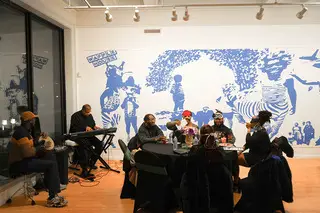 Guests gather at Community Folk Art gallery to enjoy a night of music and food.