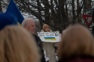 Members of the community bring signs to express grievances about the violence in Ukraine. 