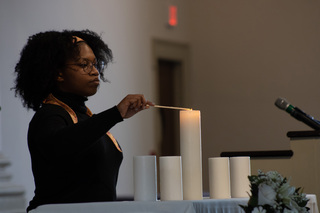 Candles were lit throughout the service to honor recently deceased members of both SU and ESF's community.