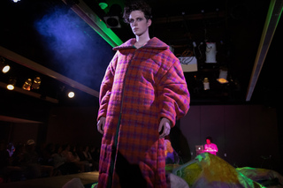 Nate LeBoeuf wears large red and pink jacket in FADS “Abiotic Wanderers” show.