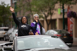 Syracuse Common Councilwoman and Grand Marshal Rasheada Caldwell rides in a convertible towards the front of the Syracuse Victory Parade as part of the Juneteenth celebrations, June 18th, 2022.