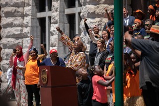 Rev. H. Bernard Alex leads a crowd outside Syracuse City Hall during the flag raising as part of Syracuse's Juneteenth celebrations, June 17th, 2022.