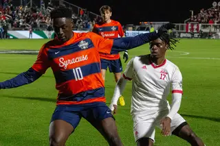 Nathan Opoku weaves his path through the defenders to make his way down the field to the goal. Opoku was the first to score a goal for the Orange in the 23rd minute of the game. 