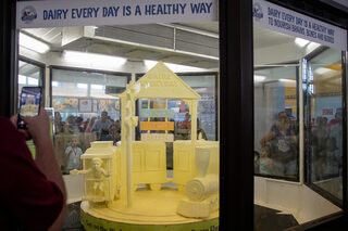 The American Dairy Association North East’s annually changing butter sculpture is a crowd marvel at the NY State Fair. For 2023, the sculpture’s theme was “Dairy Every Day is a Healthy Way – Keeping Kids' Health on Track” and featured a cow and a sign displaying different types of dairy. 
