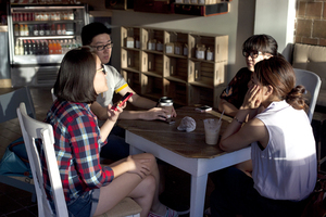 Vivienne Li talks to friends Xudong Lu, Liwen Lu and Liyuan Yu (left to right) over coffee and cold drinks after class Tuesday afternoon at Cafe Kubal, which operates in conjunction with 3fifteen. 