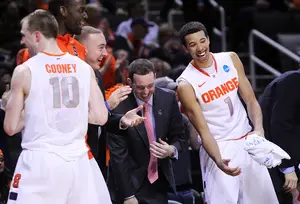 (Left to Right) Trevor Cooney #10, Baye Moussa-Keita #12, graduate manager Nick Resavy, assistant coach Gerry McNamara and Michael Carter-Williams #1 of the Syracuse Orange celebrate after a play during the game against the Montana Grizzlies