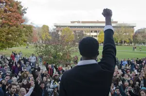 Colton Jones, a senior psychology major and a rally organizer, leads the crowd in a chant during the Diversity and Transparency Rally on Monday afternoon.