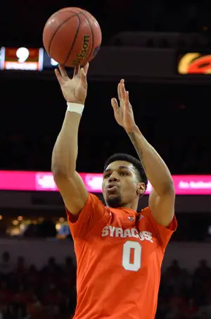 Michael Gbinije rises for a jump shot on Saturday against N.C. State. The junior forward said the thought of going pro is in his mind, but he'll have to take some time off to think.