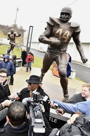 Floyd Little addresses the media following the unveiling of statues at Plaza 44 next to the Ensley Athletic Center. Statues of former SU greats Little, Jim Brown and Ernie Davis were unveiled.