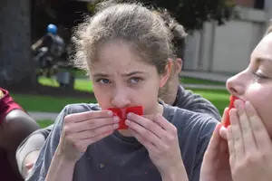 Demonstrators on Tuesday wore red tape on their mouths and stood with mattresses on the quad. 