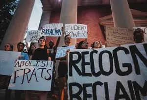 About two dozen protesters demonstrated on the Syracuse University campus Tuesday night.