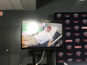 Hugh Freeze conducts a postgame interview through a TV screen.