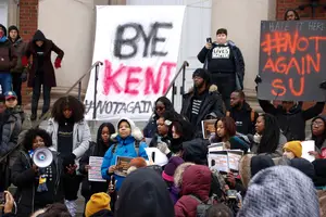 #NotAgainSU relocated to the steps of Hendricks Chapel, where they had strung a large sign between two pillars that read “Bye Kent” in black and red letters. 