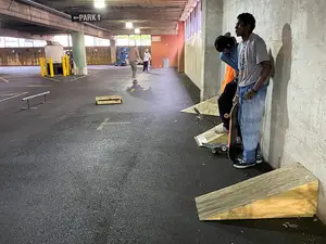 Flower Skate Shop and Forum Barber led skaters to a covered parking garage with home-made ramps and ledges for skateboarding.