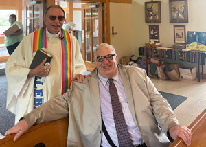 All Saints Parish Church’s pastor Fred Daley places a hand on the shoulder of Francis DeBernardo, the executive director of New Ways Ministry.
