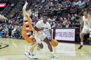 Joe Girard prevents a drive inside from Florida State's Chandler Jackson. Girard finished the game with 26 points. 