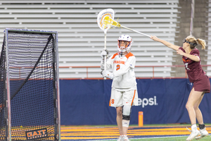 Delaney Sweitzer looks for a pass over a Virginia Tech attacker. Sweitzer recorded a career-high 15 saves in SU's 16-5 win 