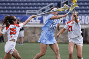 Marissa White attempts a shot in between Natalie Smith and McKenzie Olsen. In its 15-9 victory over Syracuse, North Carolina notched 10 goals in the first half alone