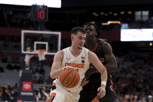 Girard (left) averaged 16.4 points in his final year with Syracuse including a career-high 31 against Richmond during the Empire Classic in late November