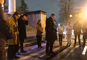SU students and faculty brave the cold, gathering in a circle of prayer. Hendricks Chapel hosted its second interfaith vigil to promote world peace amidst world violence Wednesday evening.