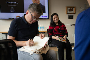 Author and activist Curtis Chin signs his book 