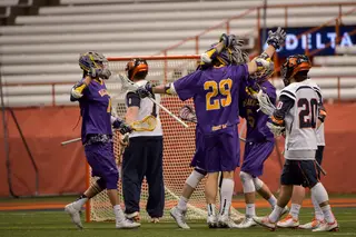 The Great Danes come together after scoring a goal against Syracuse. The two teams were tied at four after the first quarter. 