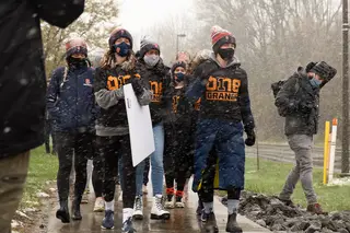 To show their support for Black athletes, administrators, coaches and students, the women's cross country team marches together through the snow.