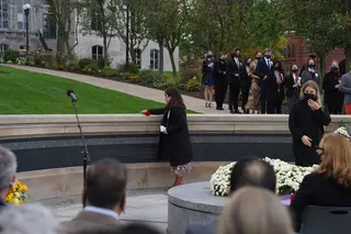 Ashley Collado, who represents Steven Berrell, lays the first rose onto the Wall of Remembrance during the Rose-Laying Ceremony.