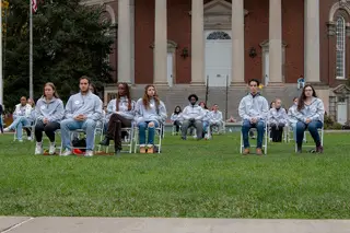 The chairs are arranged in the same layout as the Pan Am Flight 103 plane seats on the grass outside Hendricks Chapel. Each Remembrance Scholar was assigned to a chair representing the seat in which their individual sat in on the flight. 