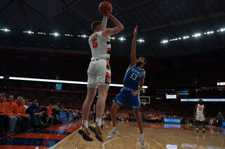 Duke’s Jacob Grandison makes an attempt to block freshman Justin Taylor’s 3-point shot. Taylor had the most playing time out of the players on the bench. 