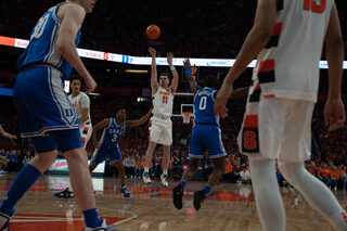 Joe Girard III takes a shot from outside the 3-point line as the Blue Devils make an attempt to block him. Girard scored 21 of the Orange’s 55 points. 