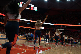 Members of the Syracuse University Dance Team take the court to perform during a media timeout. The dance team was accompanied by the other members of the spirit squad — the cheer team and Sitrus Pep Band.
