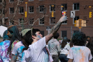 An attendee captures the lively, multicolored event in a selfie.