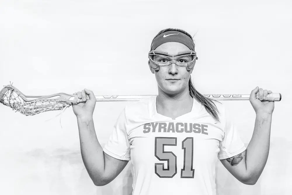 Emily Hawryschuk poses for a portrait photo with a lacrosse stick