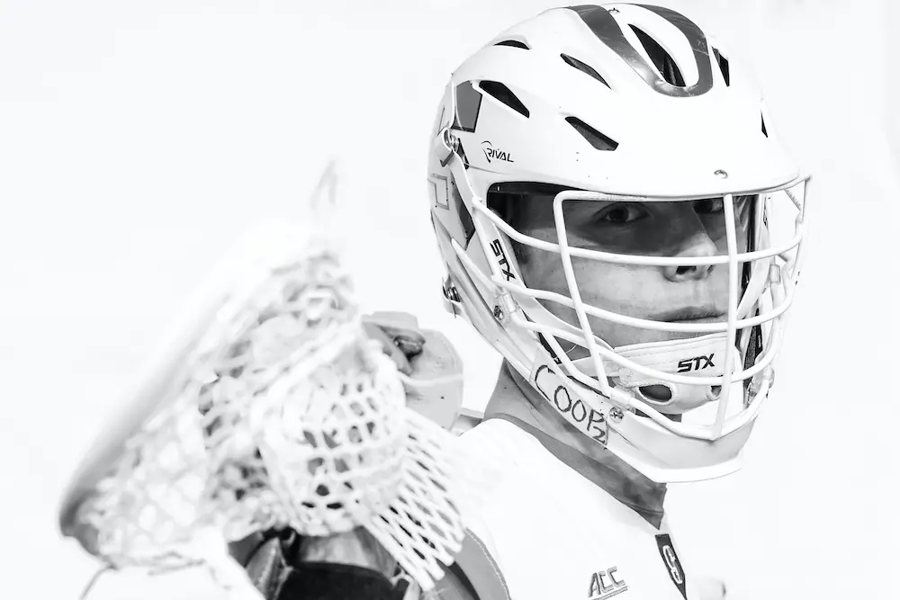 Tucker Dordevic stares intently with his lacrosse stick